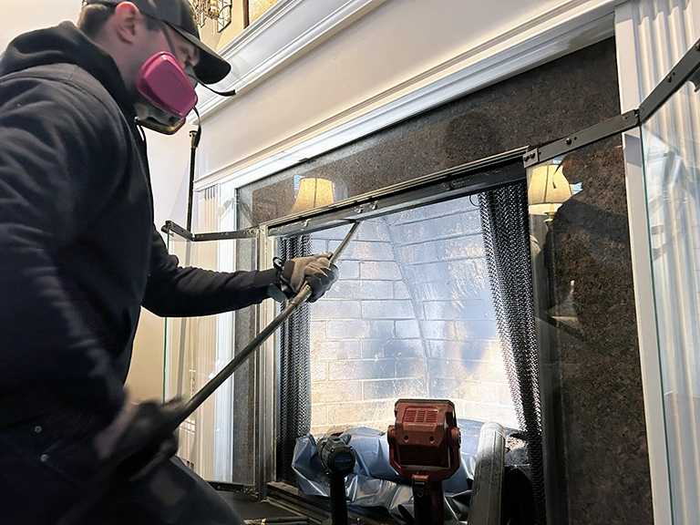 Workers sweeping chimney