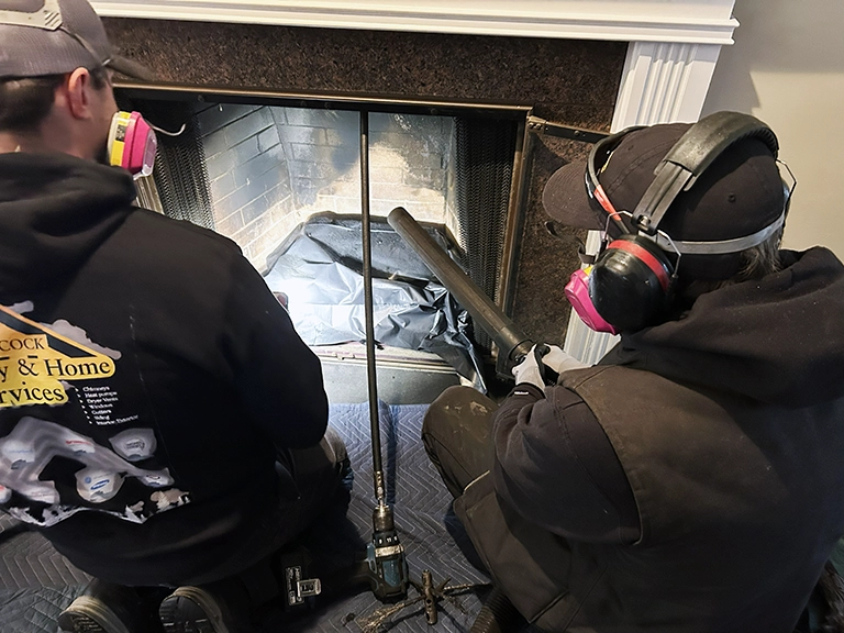 Workers sweeping chimney